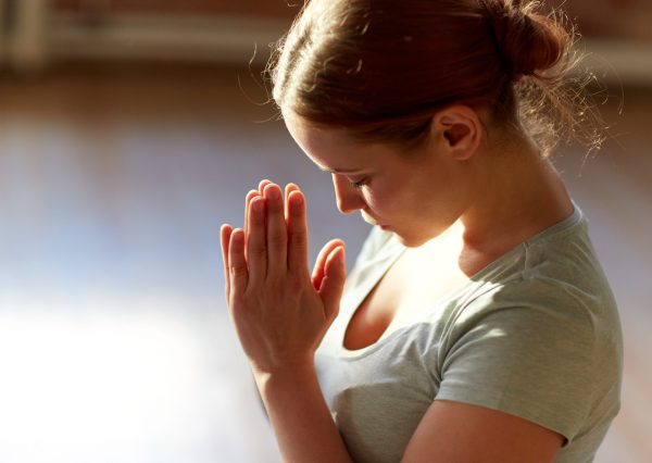 close up of woman meditating at yoga studio
